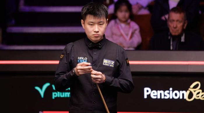 Zhao Xintong opens title defence with win over Liam Highfield at Crucible